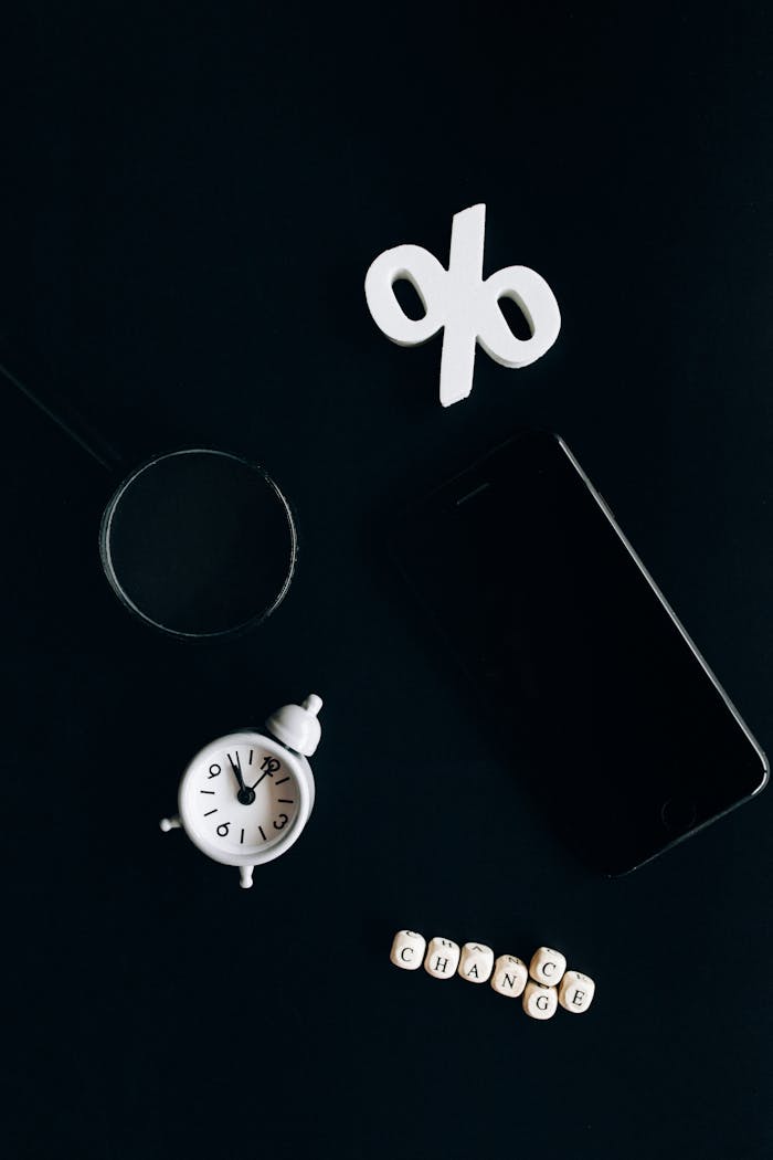 Stylish composition of clock, symbols, and text representing financial change on a dark background.